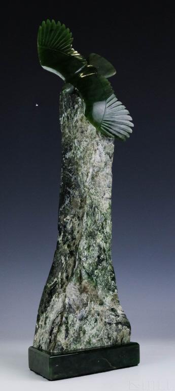 Lyle Sopel (Canadian, b.1951) Jade Eagle Sculpture: Lyle Sopel (Canadian, b.1951) Hand carved jadeite figure of a flying eagle. Finely detailed carving of the bird of prey with wings stretched out, mounted upon raw jadeite. Signed on base "Sopel E.219"