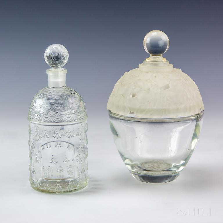 LOT 2 Dilys Laura Ashley Guerlain Perfume Bottle: Lot of 2 vintage perfume bottles. Includes Dilys by Laura Ashley 400ml store display perfume bottle. Featuring frosted lucite floral top and smooth clear crystal bottom. "Dilys" etched in front of bot
