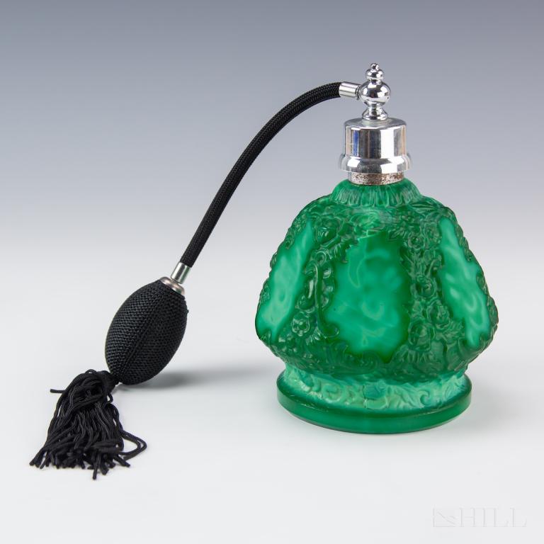 Malachite Glass Czech Perfume Atomizer Bottle: Malachite glass atomizer perfume bottle. Heavily carved floral design. Bottle: 6 in. x 4 1/2 in. Atomizer is in like new condition. Bottle has normal age wear. Hill Auction Gallery in house USA contin