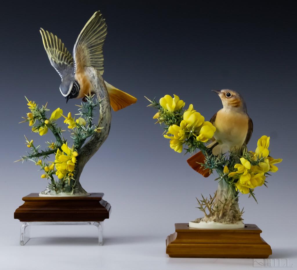 2 Royal Worcester Porcelain Redstarts & Gorse Bird: Royal Worcester porcelain figurines. Features hand painted decoration over the form a pair of Redstarts on thorny Gorse. Measures 11" x 7" x 6" approximately. Marked on base. Comes with wood stand. Go