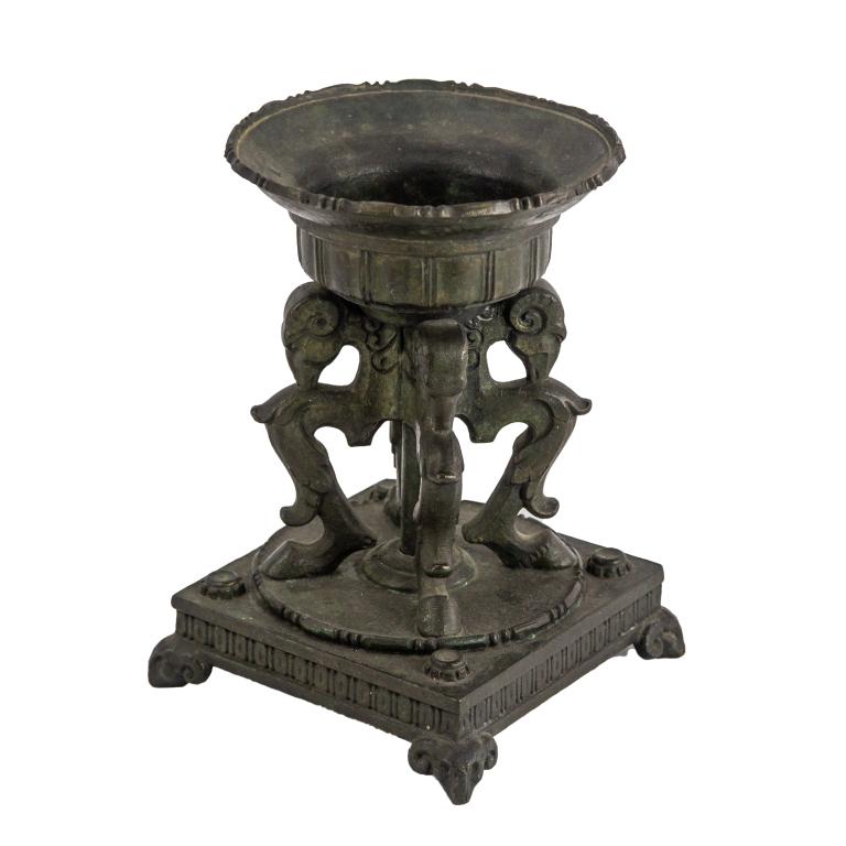 Oscar Bach Bronze Rams Head Garniture Tazza Base: Oscar Bach Tazza base or garniture. Features rams head body with footed base. Marked on base. Measures 6 1/2in. x 4 1/2in. x 4 1/2in. Good overall condition with minor wear. Hill Auction Gallery in ho