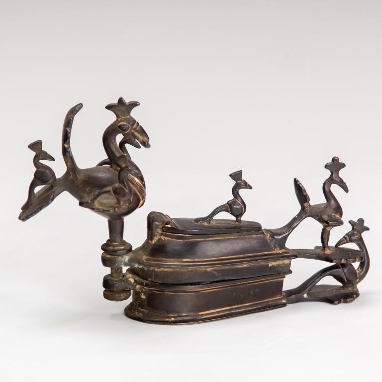Persian Khorasan Bronze Bird Form Hinged Box, Lid: Old Persian bronze hinged box. Features elaborate bronze construction with numerous birds decorating the piece. No apparent markings. Good overall condition with age related wear. Hill Auction Gallery