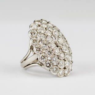 Cartier Platinum 6.8 CTTW Diamond Cluster Ring VTG: Guaranteed Authentic Cartier platinum and diamond ring. Features an oval dome form with tiered rows of bezel set diamonds with a total diamond weight of approximately 6.8 carats. Size 6.5.