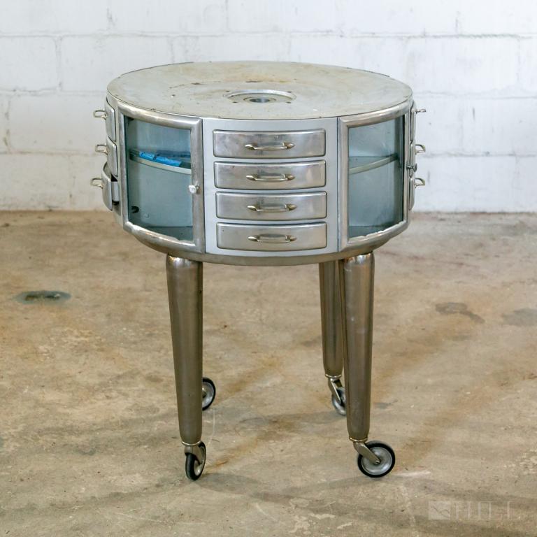 Leon Martin Round Girator Dentist Cabinet MODERN: Vintage industrial Girator dentist's medical cabinet designed by Leon Martin circa 1940's. Polished aluminum fitted with glass lined shelves. Overall 34 in. x 27 in. Good to Fair condition with mild s