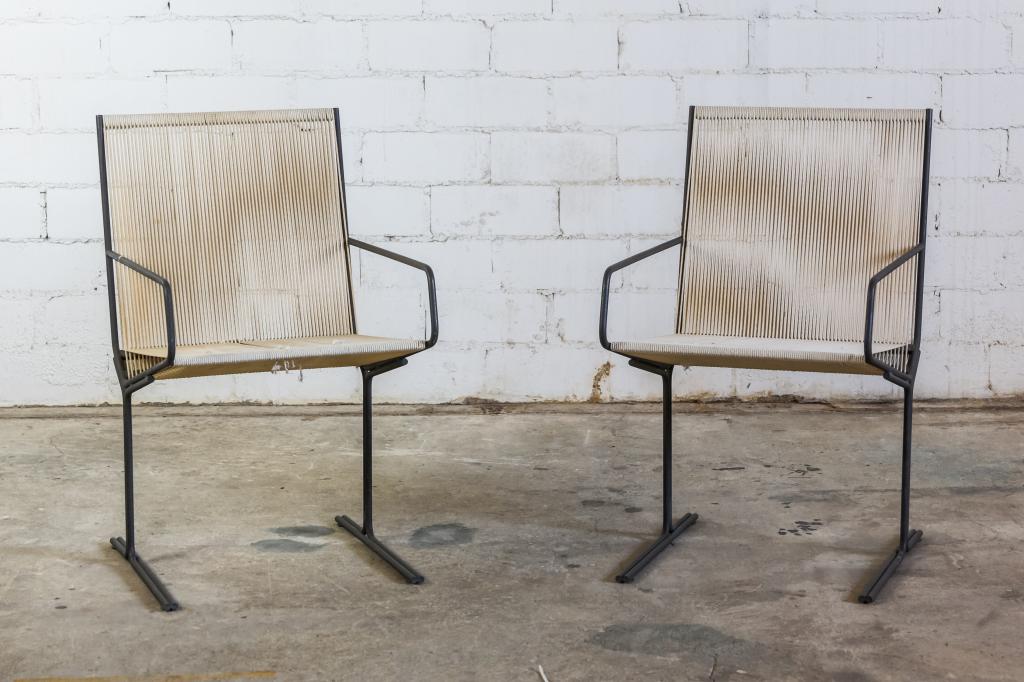 2 Mid Century Modern Alan Gould Style Rope Chairs: Pair of mid century modern "Bow" rope chairs in the style of Alan Gould. Bronze patinated iron frame with string or rope seats. Each 32 in x 19 in. x 24 in. Good to Fair condition with staining and fr