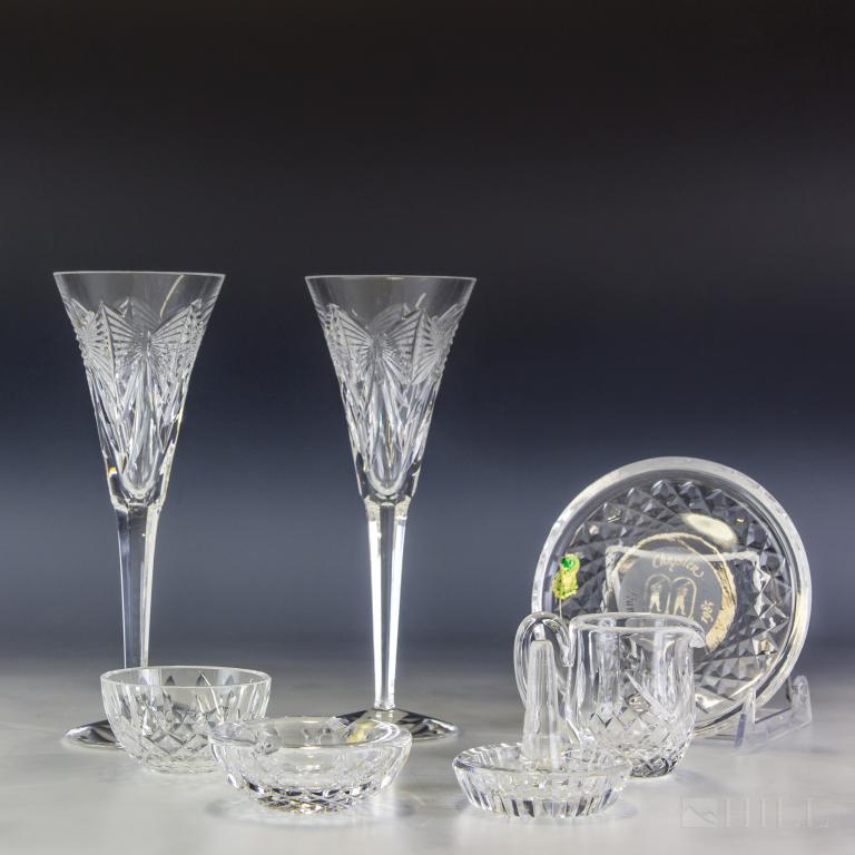 Waterford Crystal Lot 7 Wine Glasses & Accessories: Collection of Irish crystal items from Waterford. Features a pair of champagne flutes in the Millennium Happiness pattern. Also features a wine coaster, ring holder, creamer, nut dish and ashtray. All