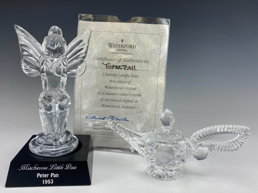 LOT 2 Waterford Crystal Disney Tinker Aladdin Lamp: Two Waterford Crystal Disney collector pieces. Includes "Mischievous Little Pixie" (8 in. x 4 in. x 4 in.) From Disney's 1953 Peter Pan, and the Genie's lamp ( 8 in. x 4 in. x 3 in.) from Disney's 199