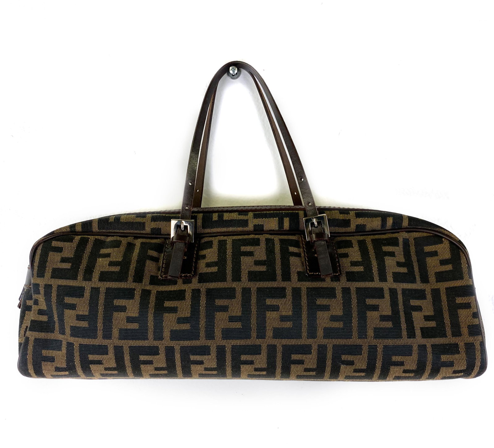 Fendi Vintage Italian Zucca Oblique Handbag Purse: Fendi Italian designer handbag. Features canvas with the zucca logo pattern with leather handles. Signed on interior. Measures 5 1/2 in. x 15 in. x 3 1/2 in. with a, adjustable 6 in. strap drop. Good 