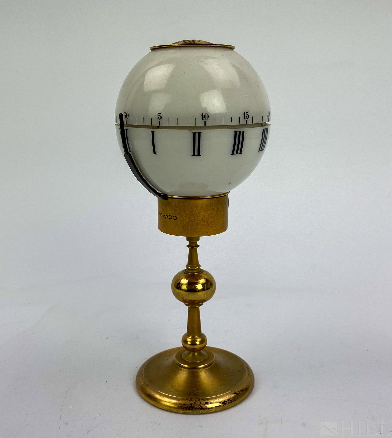 Rare Movado Tempus Fugit 8 Day Brass Globe Clock: Rare Movado desk clock. Features a rotating dome that indicates the time and fixed to a gilt brass base. Measures 7 in. x 3 in. x 3 in. Signed Movado Factories Swiss 8 Day. Good overall condition with