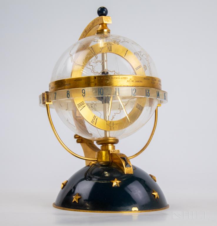 Gubelin Vintage Mid Century Globe World Time Clock: Rare globe clock by Gubelin. Comes in it's original case. Features a lucite globe over working clock with rotating brass center ring. Base is enameled and features raised stars. Marked Gubelin Metal D