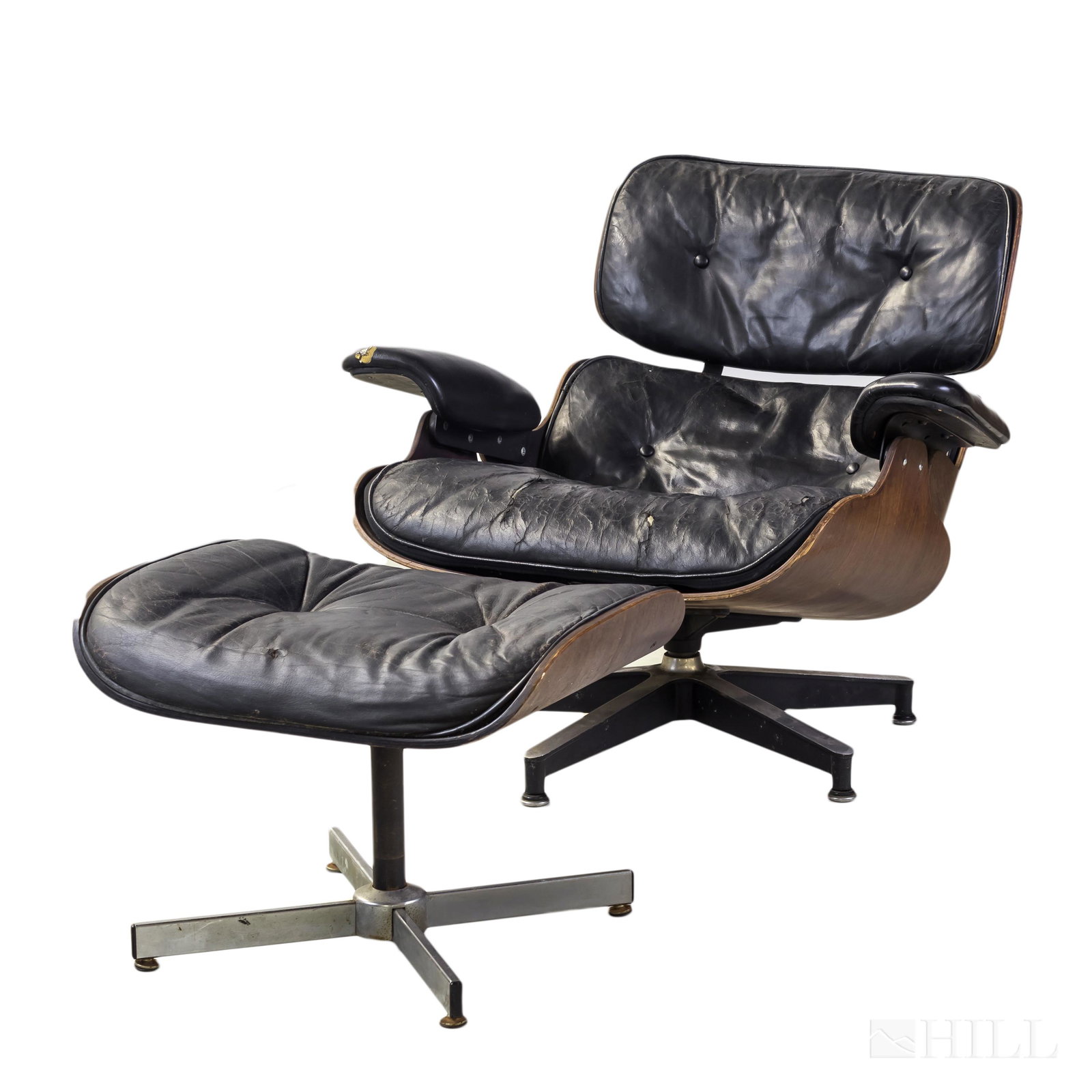 Herman Miller Eames Black Lounge Chair & Ottoman: Charles and Ray Eames (American, 1907-1978, 1912-1988) Original Lounge chair and ottoman. Featuring laminated wood, cast and enameled aluminum. Chair retaining original Herman Miller inc. paper patent