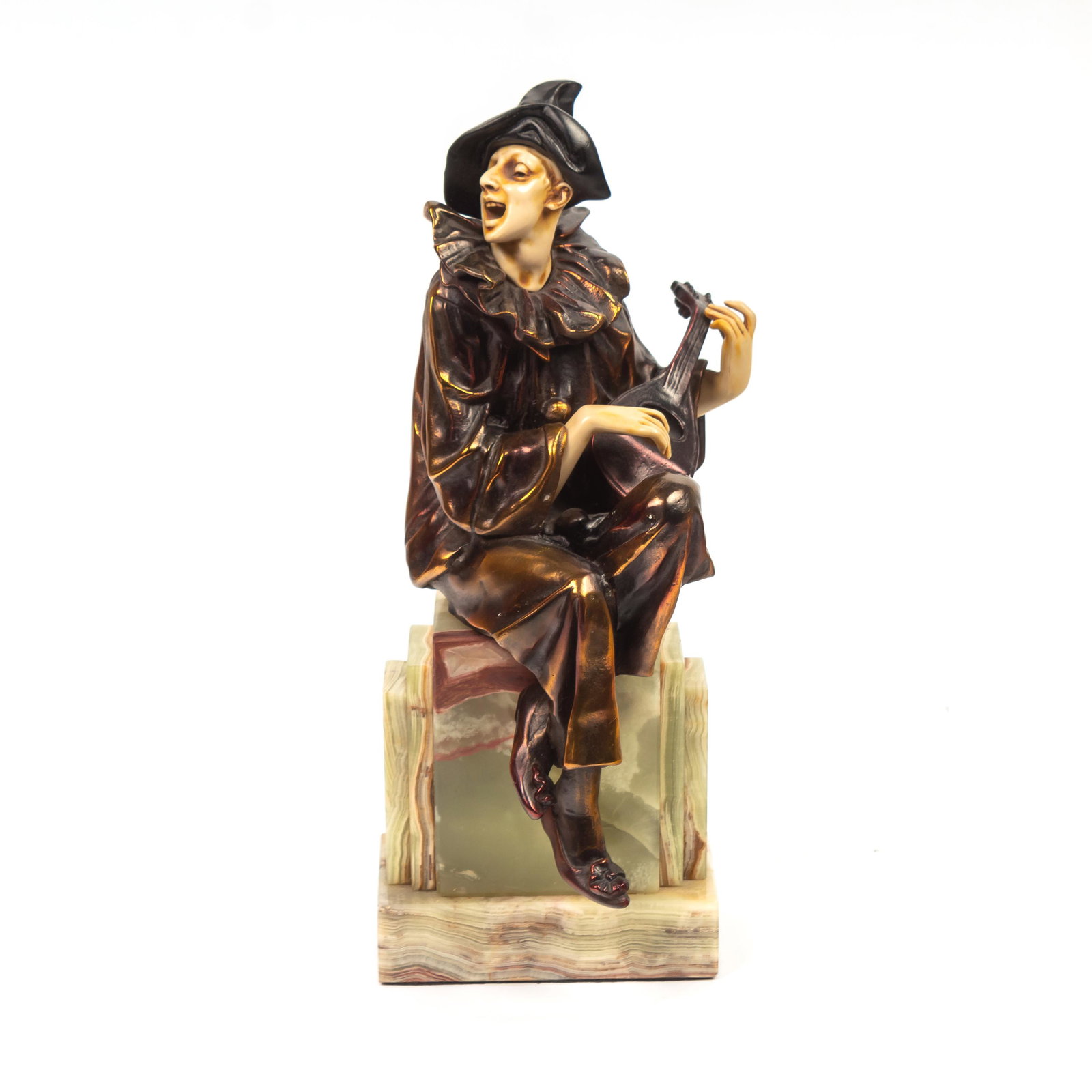 Art Deco Pierrot Sculpture Manner Demetre Chiparus: Art Deco style figurine statue of a clown in the Harlequin Pierrot motif, seated and playing a stringed instrument mandolin, modeled in resin or similar material and decorated to simulate bronze and P