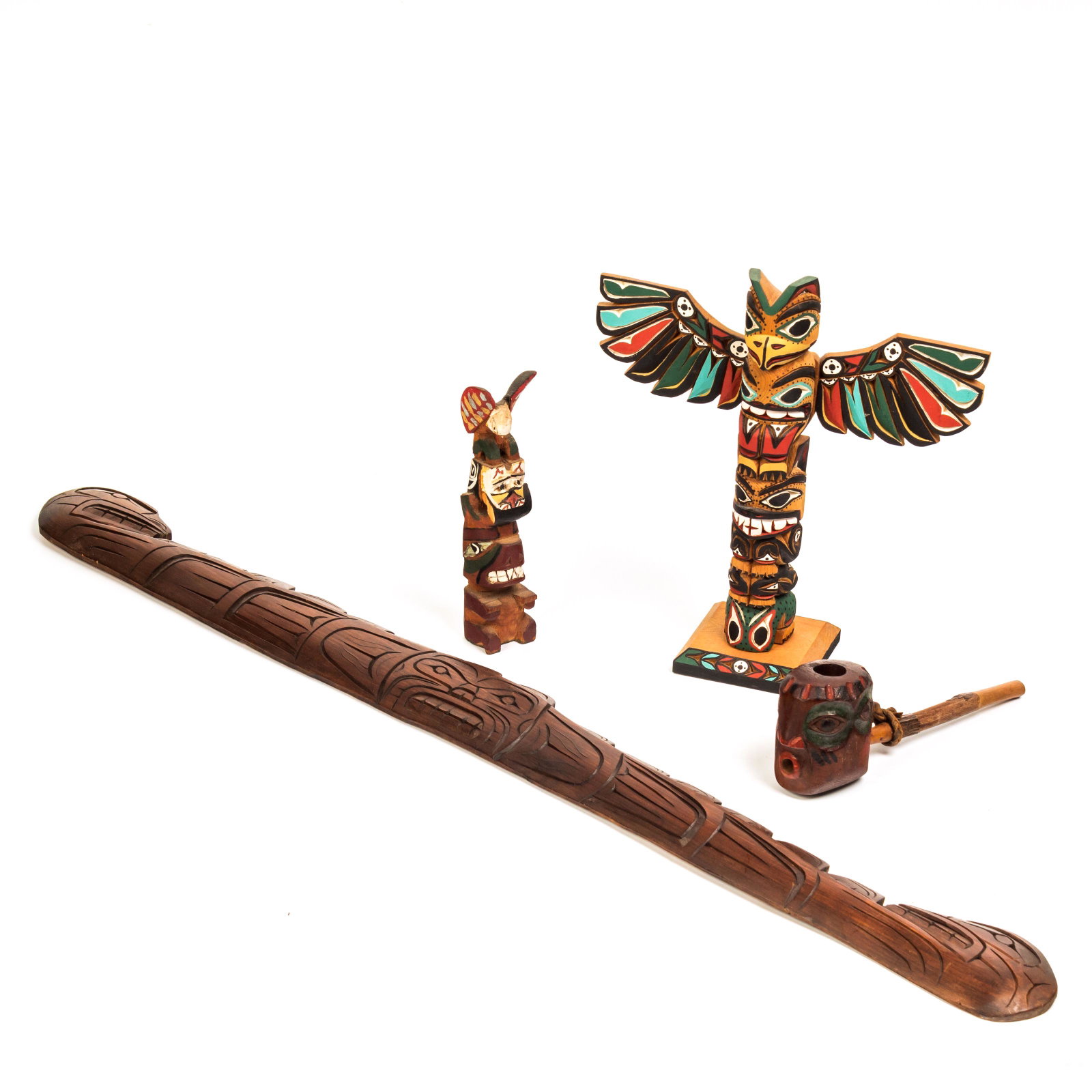 4 Alaska Canada Tribe Pipe Totem Wood Carvings LOT: A collection of 4 Native American Indian, Canadian Pacific Northwest tribal wood carvings, including two totem poles. Back of the larger totem is signed "King of Nitinat Tribe;" smaller totem pole sig