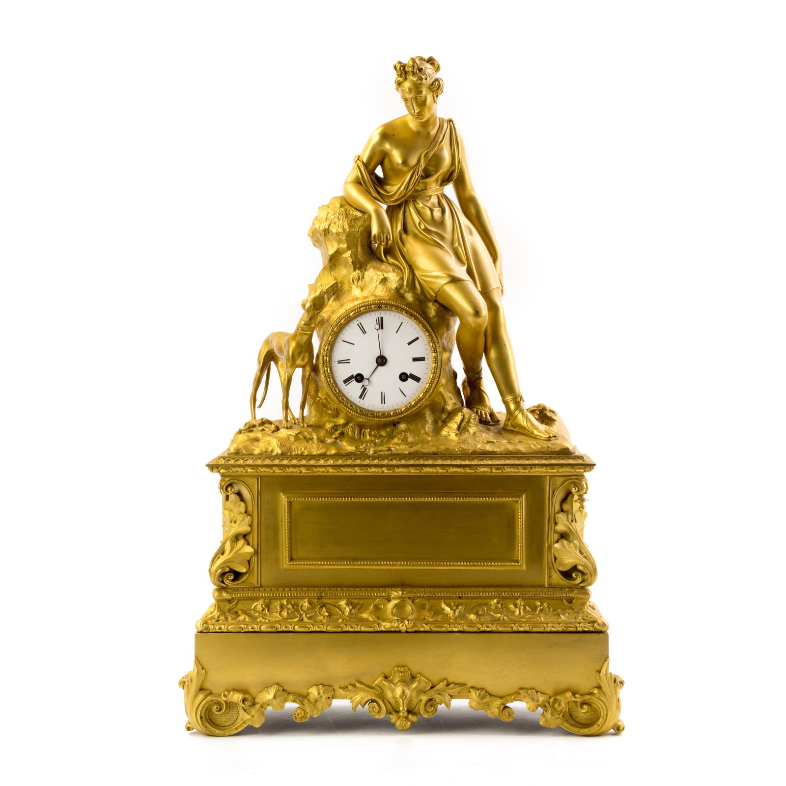 French Empire Ormolu Bronze Neoclassical Clock: A striking Victorian interior decor timepiece bearing the manner of late French Empire Period in a solid gilt bronze case. A central figural sculpture of a Neoclassical woman in Greco Roman costume wi