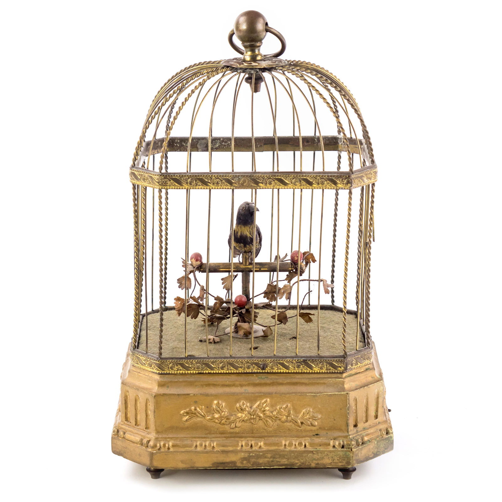 Wind-up Helvetic Automaton Singing Bird in Cage: A delicate gilt brass metal octagonal shaped cage with elegant relief flora to all sides and a functioning automaton bird that sings when wound up via the underside key. Good vintage condition, with r