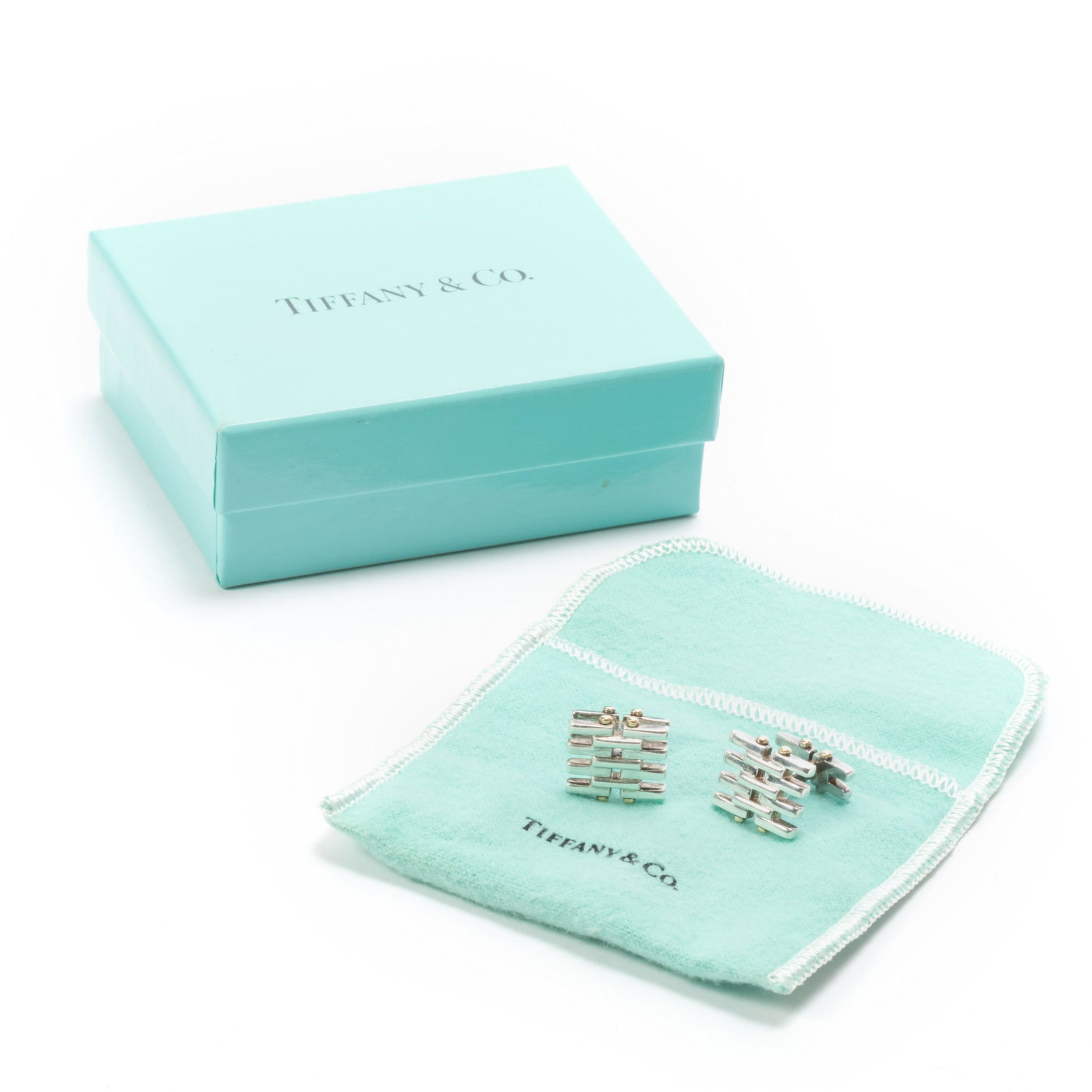 Tiffany & Co. Sterling Silver 18k Cufflinks PAIR: Tiffany & Co. (American). Pair of signed cufflinks. Crafted of Sterling silver with 18k gold accents. Gate design with interlocking horizontal bars held together with gold brads. Signed T&Co 925 750. 
