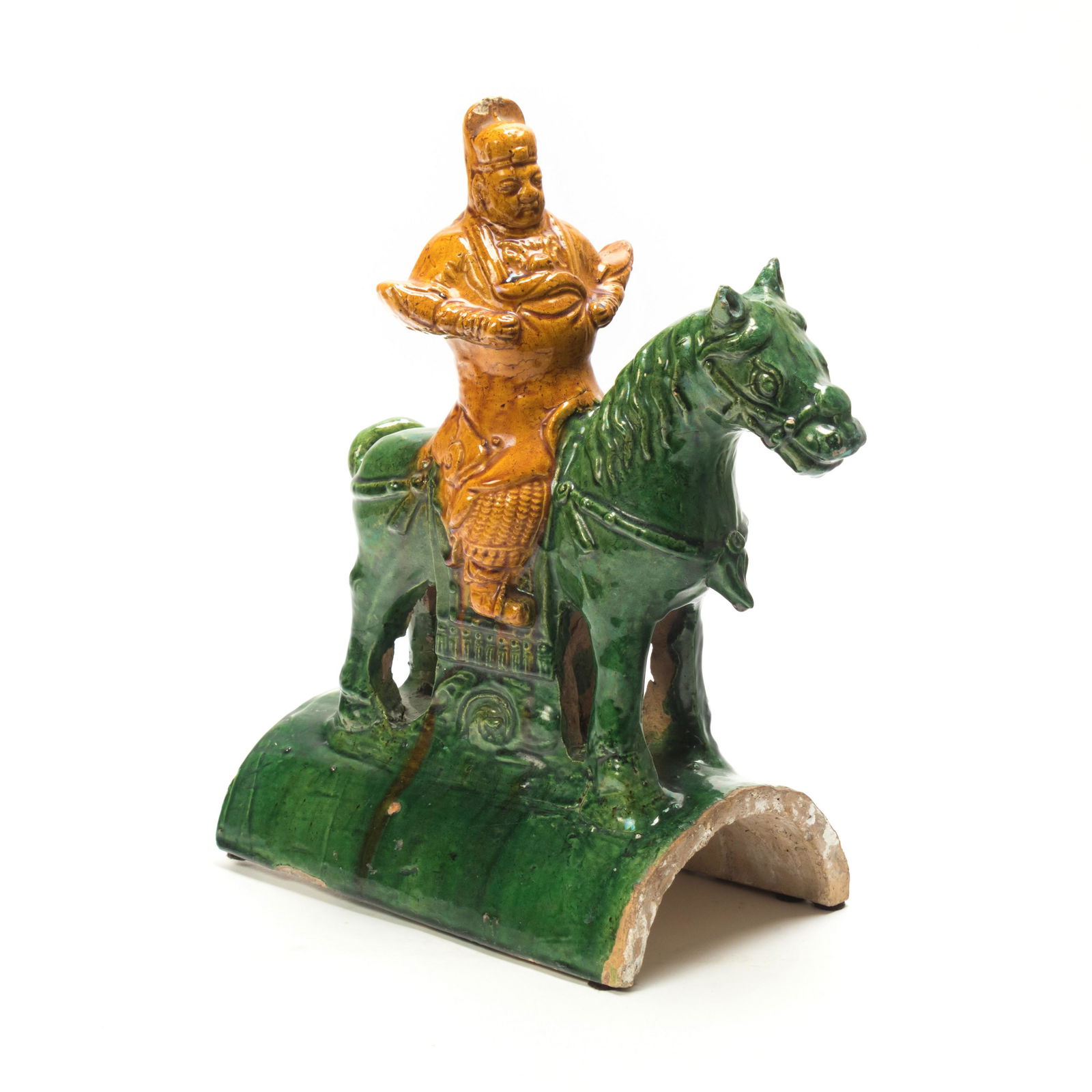 Chinese Sancai Pottery Horse w Rider Roof Tile: Chinese pottery with green and yellow glaze modeled as a battle horse with warrior on back. From the Estate of Mrs. Susan S. Dillon, Jupiter, FL. Good condition with mild surface wear, small chips and