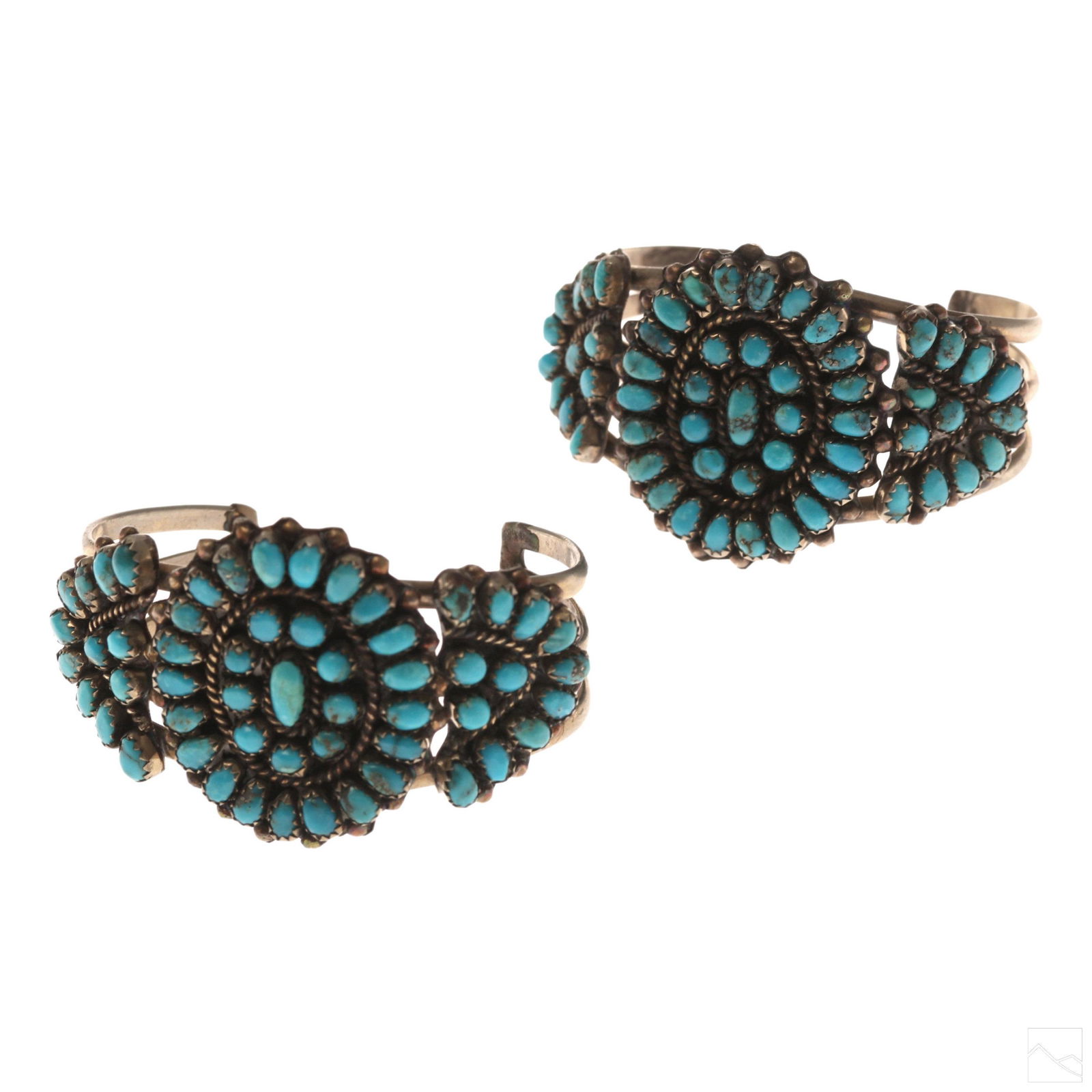 Native American Petit Point Turquoise Bracelets: Pair of Native American Zuni sterling silver and turquoise petit point cuff bracelets. Features a series of natural turquoise cabochons. Interior measures 5 1/2 in. including gap. Measures 38mm wide.