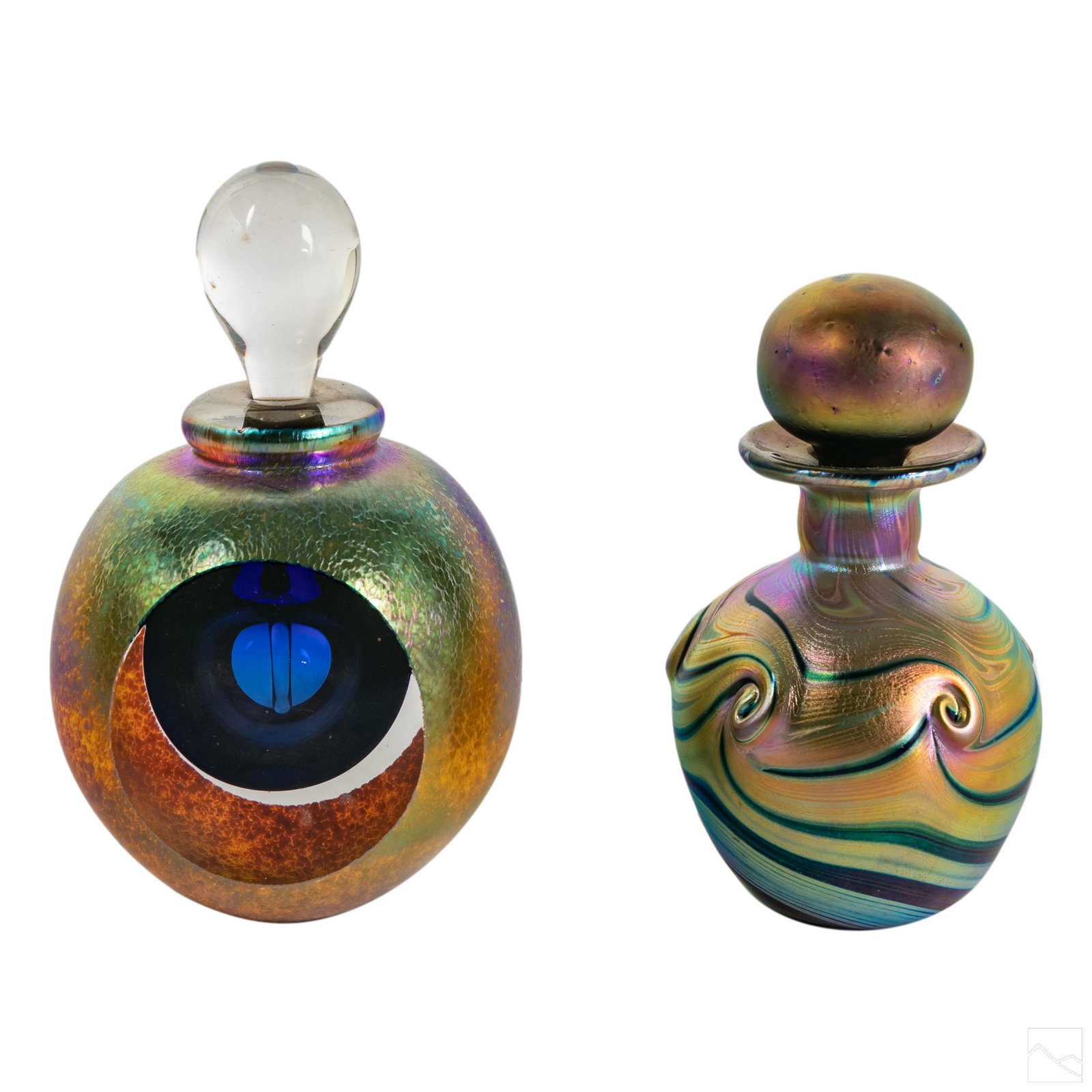 Studio Art Glass Iridescent Perfume Bottles Group: Two fine vintage studio art glass perfume bottles. Includes (1) 4 in. Iridescent glass perfume with clear glass stop and facet polished sides. No apparent signature. And (1) 3 1/2 in. iridescent art g