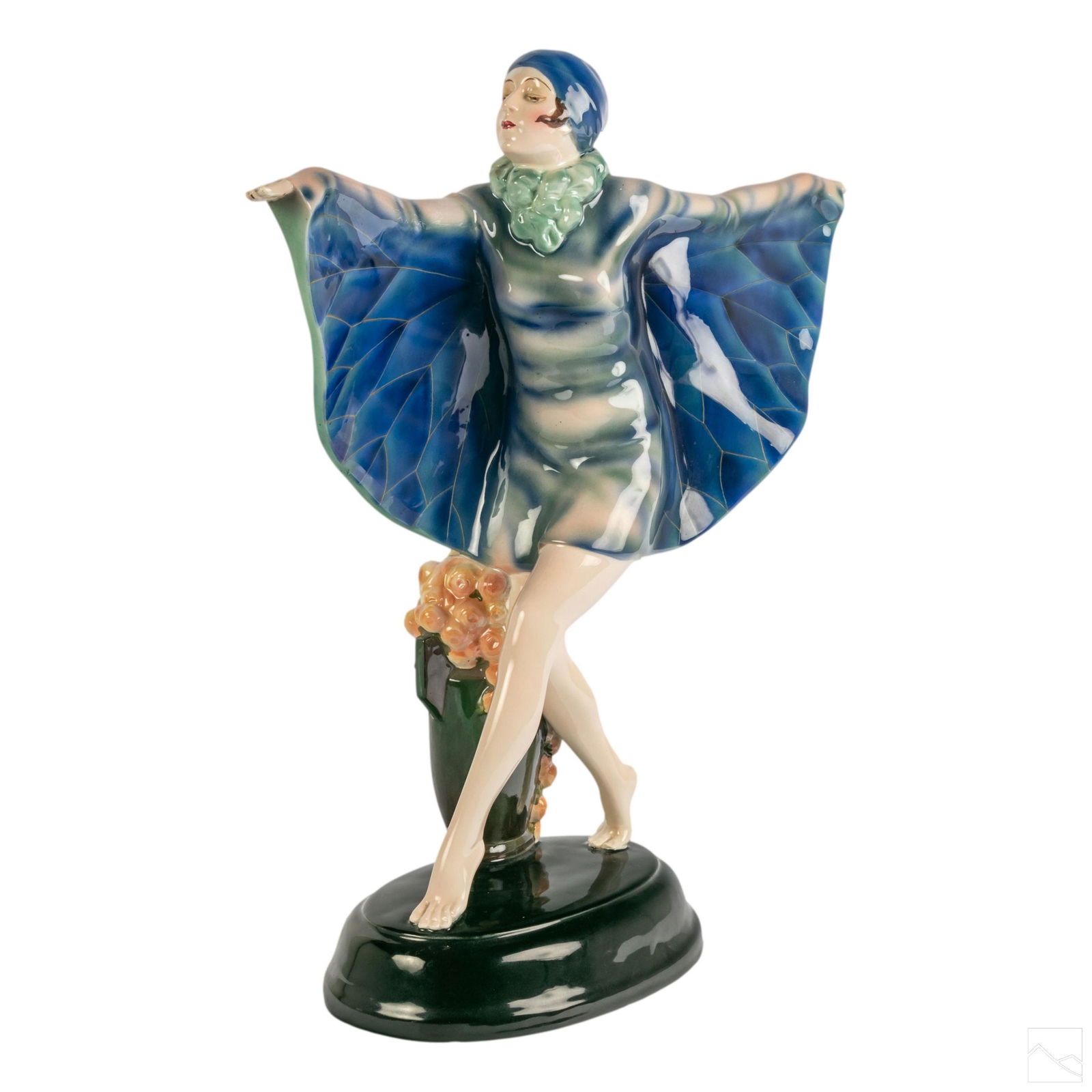 Goldscheider Art Deco Butterfly Dancer Figurine: Goldscheider Austrian glazed porcelain Art Deco Butterfly Dancer sculpture designed by Josef Lorenzl (1892-1950). Modeled in blue cap with winged cape, and a vase adorned with pink roses. Signed on bo