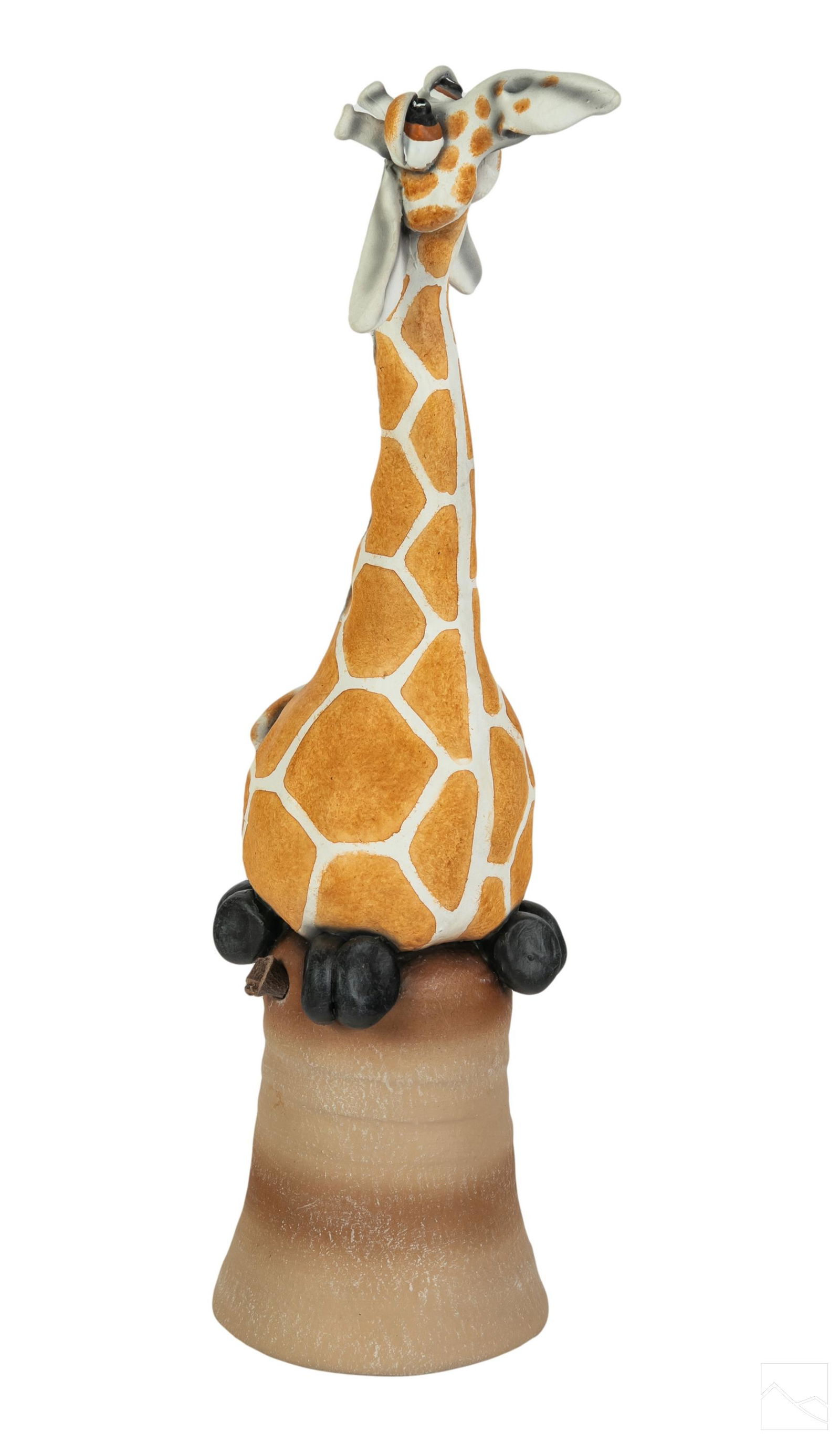 Todd Warner b.1945 Pottery Giraffe Bell Sculpture: Todd J. Warner (American, born 1945). Art pottery figurine. A whimsical bisque ceramic wildlife sculpture featuring a central giraffe forming the handle of a bell. Leather cord fastener for ceramic ba
