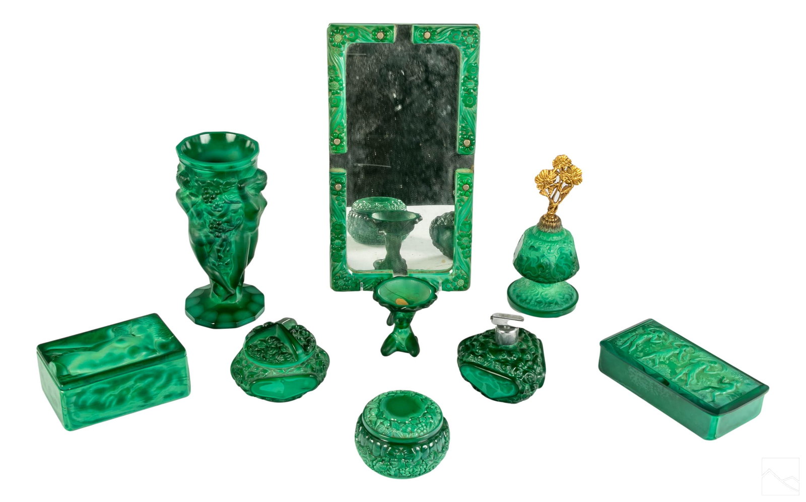 Art Deco Malachite Glass Vanity Dresser Assortment: Collection of nine Art Deco boxes, scent perfume bottles and other vanity items made in striking emerald green malachite glass. Includes: one footed vanity plateau mirror, having small area of loss to