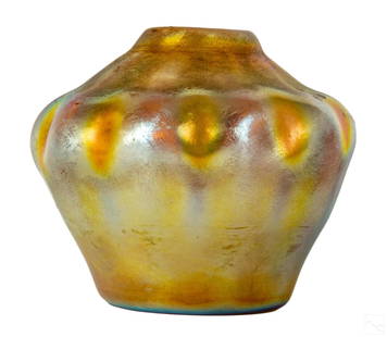 Louis C. Tiffany Gold Favrile Pinched Glass Vase: Louis Comfort Tiffany (American, 1848-1933). A golden iridescent Favrile art glass vase. Squat form with pinched opening to top. Signed LCT on bottom numbered W6100.Dimensions: 4.50 X 5 X 5 in. 