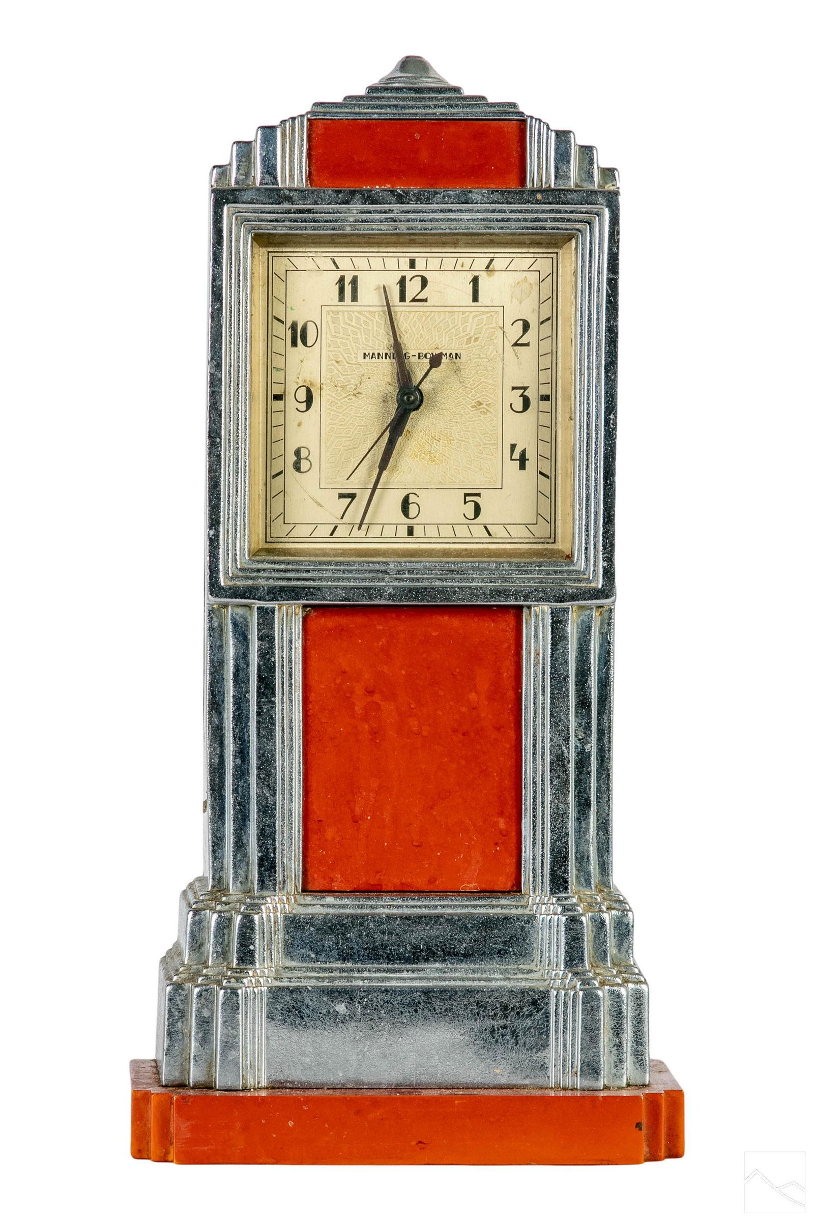 Manning Bowman Art Deco Skyscraper Clock # K906: A tall Art Deco mantel clock in the form of a skyscraper. Metal plated surface with bright orange panels. Model K906, designed by Jean George Theobald (American, 1873-1952) for Manning Bowman & Co. (M