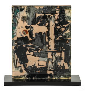 Arthur Secunda 1927-2022 Modern Lucite Sculpture: Arthur Secunda (American, 1927-2022). A cast lucite sculpture. A rectangular form featuring inclusion of charred objects collected after the 1968 Watts Riots in Los Angeles. Presented with a black rec