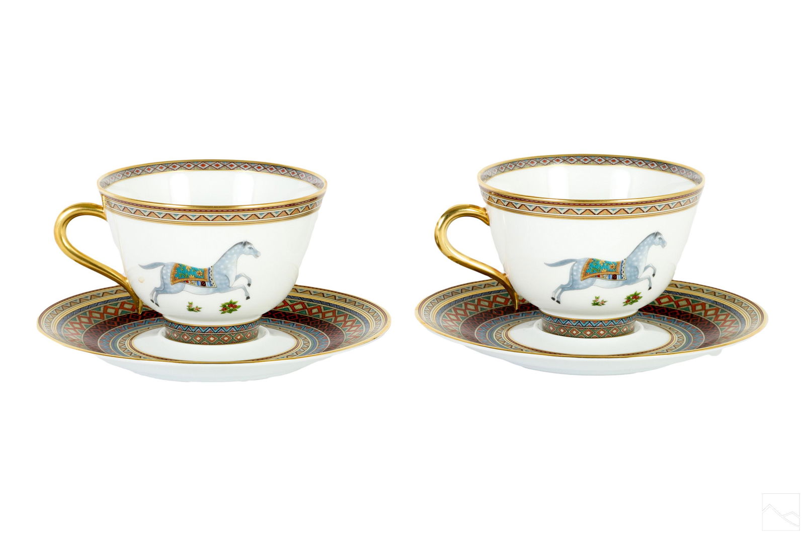 Hermes Cheval d'Orient Tea Cups & Saucers 4pc. SET: A four (4) piece Hermes French porcelain tea set. Two tea or coffee cups with matching saucers, produced in the Cheval d'Orient pattern. Cups having large footed bodies with gilded handles. All pieces