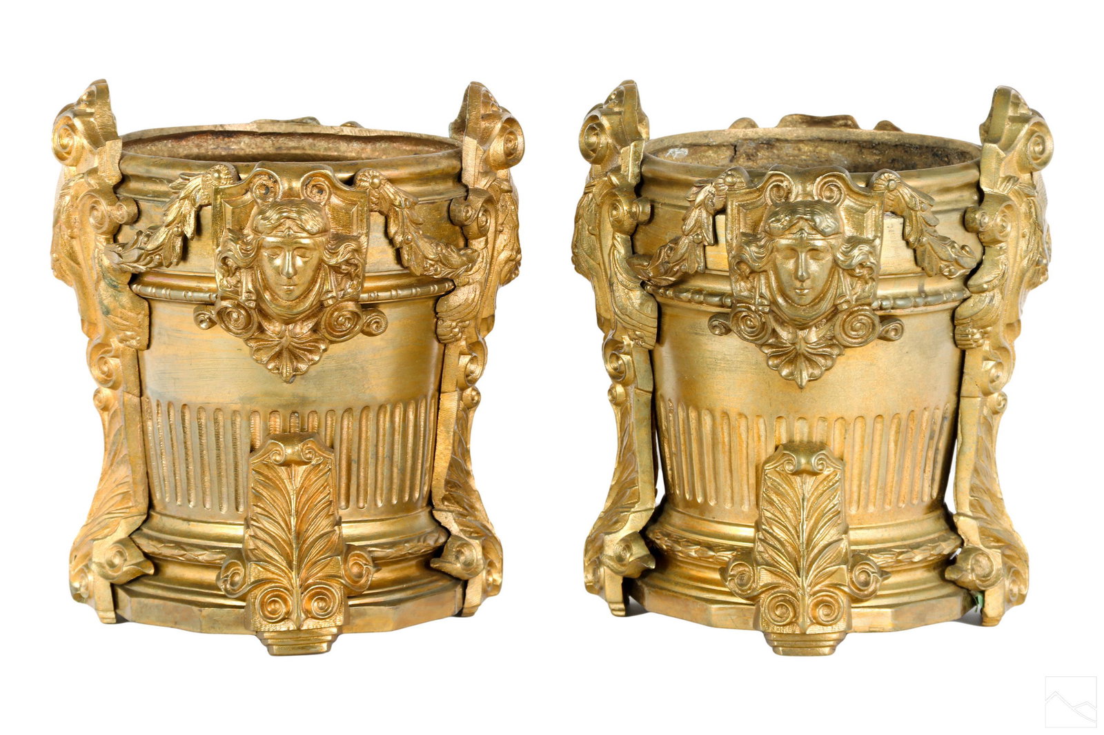 French Empire Antique Pair Dore Bronze Jardinieres: A pair of late French Empire 19th Century antique Neoclassical gilt bronze jardiniere floral planters. Two ornate planters embellished with raised relief and flora face shields. Inserts not included. 