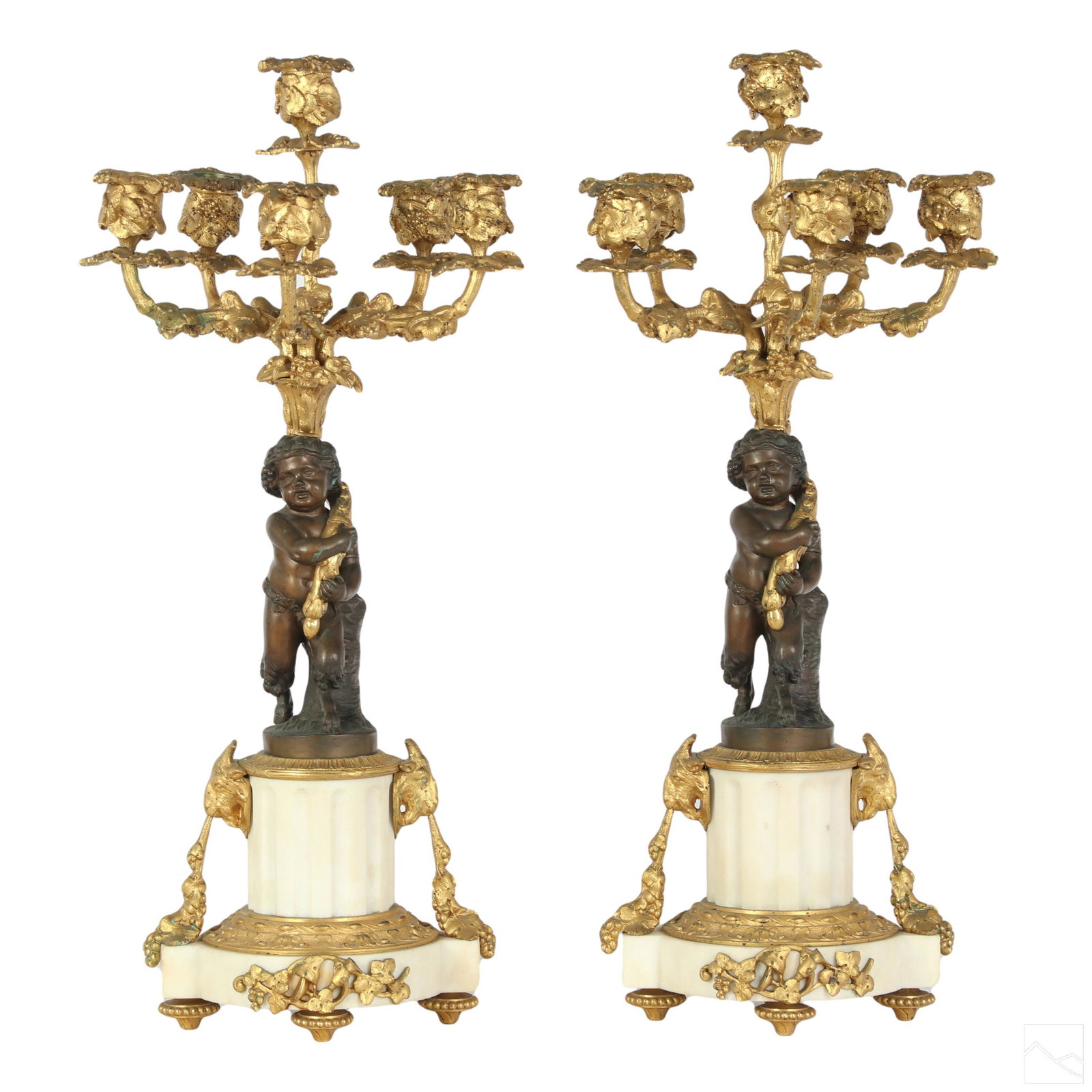 French Empire Antique Dore Bronze Gilt Candelabras: A pair of exemplary antique five arm candelabra fixtures, produced circa early 20th Century or possibly early. Bronze, carved marble, and other elements. Features central figural putti style Pan Satyr