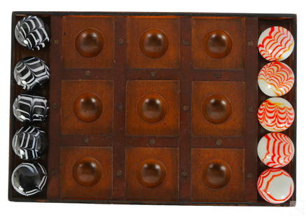 Modern Wood Tic Tac Toe Game & Glass Playing Orbs: A modern Tic Tac Toe wood game board with glass playing pieces. Game board divided into the nine sections with tray holding five (5) black and white and white and orange blown glass ball pieces.