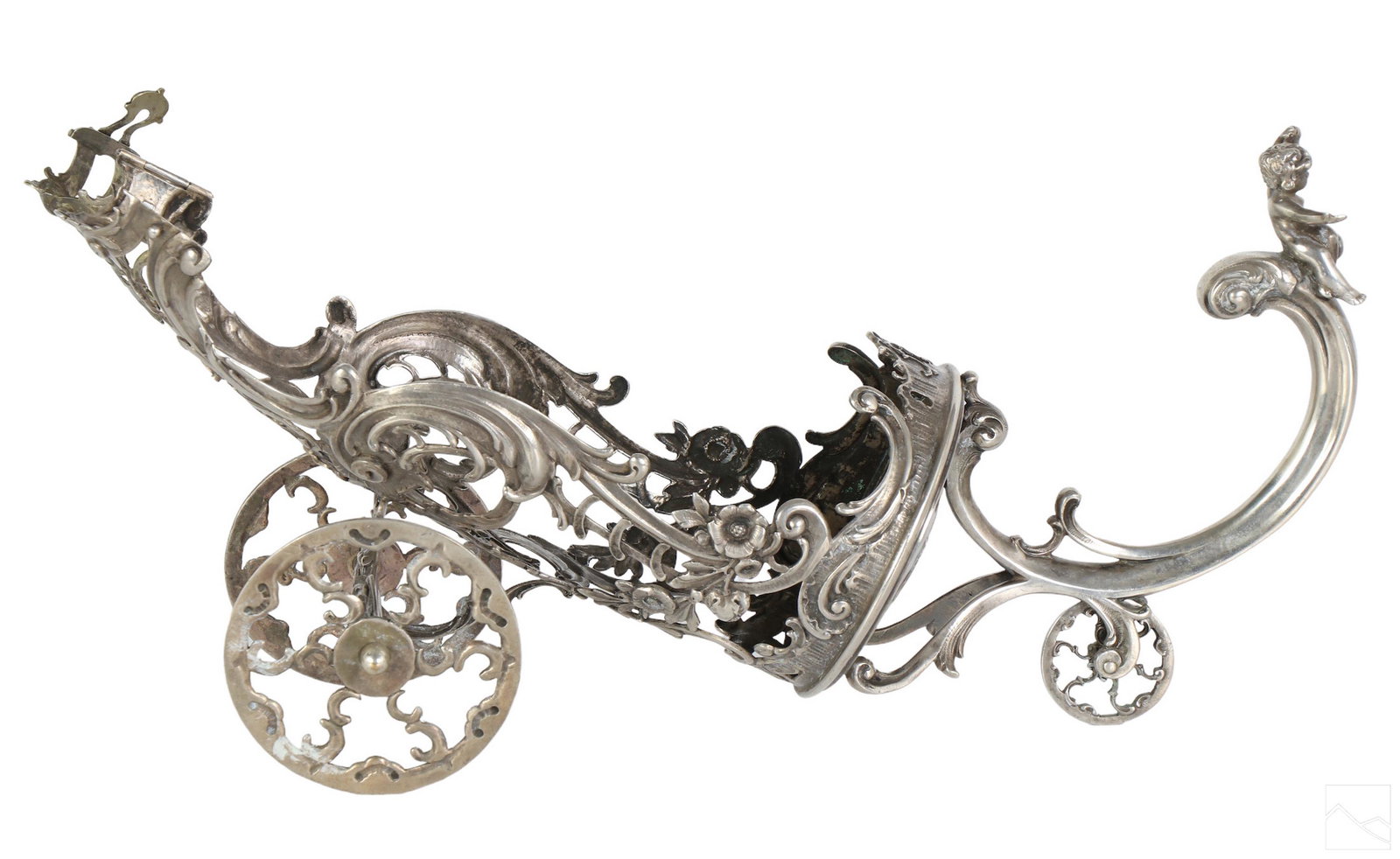 German 800 Silver Baroque Wine Caddy Bottle Holder: Antique 800 silver wine bottle cart. A ornate foliate frame design. Features three wheels, a hinged latch for neck of the bottle, and scrolling handle topped by a waving figural putti angel holding up