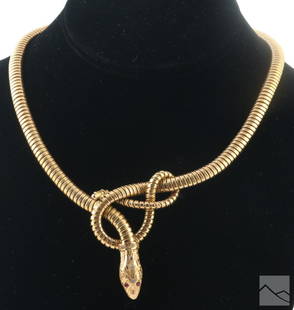 18K Gold Antique Egyptian Tubogas Serpent Necklace: An 18k gold antique ladies Egyptian designer knotted Cleopatra asp snake necklace. A tubogas style link design with a knotted snake at the center. Articulated head set with lab created rubies and