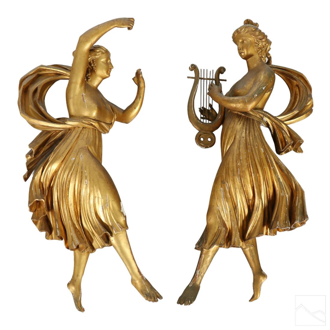 Italian Antique Gilt Wood Figural Wall Sculptures: A pair of exemplary antique carved wood statues. Opposing figural wall hangings of female figures playing harps. Hand applied gilt decoration. Dimensions: 33 X 16 X 7 in. Condition: Good to fair