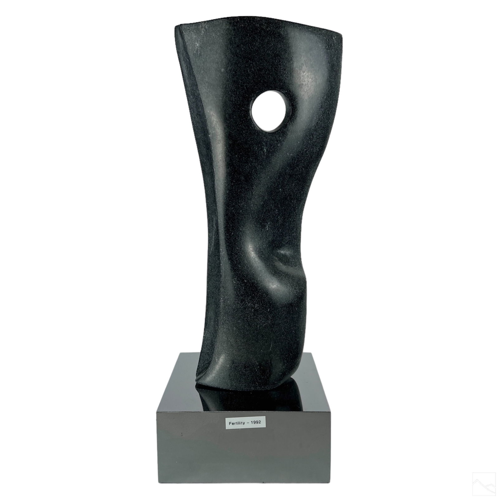 Modernist Abstract Carved Black Marble Sculpture: Mystery Artist (20th Century). A hand carved black marble stone statue. Titled, "Fertility 1992". A Modernist work, with a central abstract pierced figure. Mounted to a chrome plinth. No apparent sign