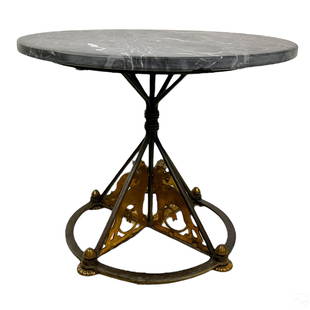 French Art Deco Lions Marble and Iron Accent Table: A French designer mixed media accent table. Marble and wrought iron. Moderne style wrought iron base with scrolling openwork panels depicting side facing Art Deco lions over a flat hoop base frame and