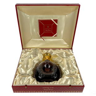 Remy Martin Louis XIII and Baccarat Bottle SEALED: A sealed unopened bottle of Remy Martin Louis XIII French Grande Champagne Cognac liquor. Presented in a Baccarat French crystal art glass decanter. In sealed condition. Accompanied with red fitted pr