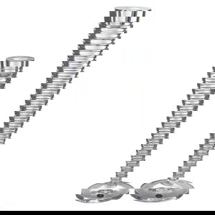 Steuben Crystal Pair Evening Candlesticks SIGNED: An estate collection featuring two (2) Steuben crystal candlestick holders, produced in the Evening pattern. Modernist designs with ribbed clear glass bodies that taper from narrow bottom to thick sum