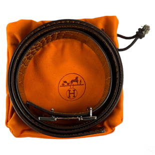 Hermes Designer Crocodile Leather Belt and Buckle: A Hermes Paris French designer crocodile leather belt strap. Rich burgundy brown leather in smooth Porosus crocodile leather designed with an eye catching satin finish. Impressed manufacturer signatur