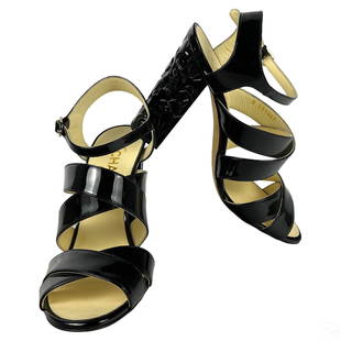 Chanel French Black Patent Leather Floral Sandals: A pair of Chanel French designer sandals. Crafted from black patent leather, featuring a floral repousse heel, CC embellishment and scrappy design. Shoe size 38 (European). Lightly preowned accompanie