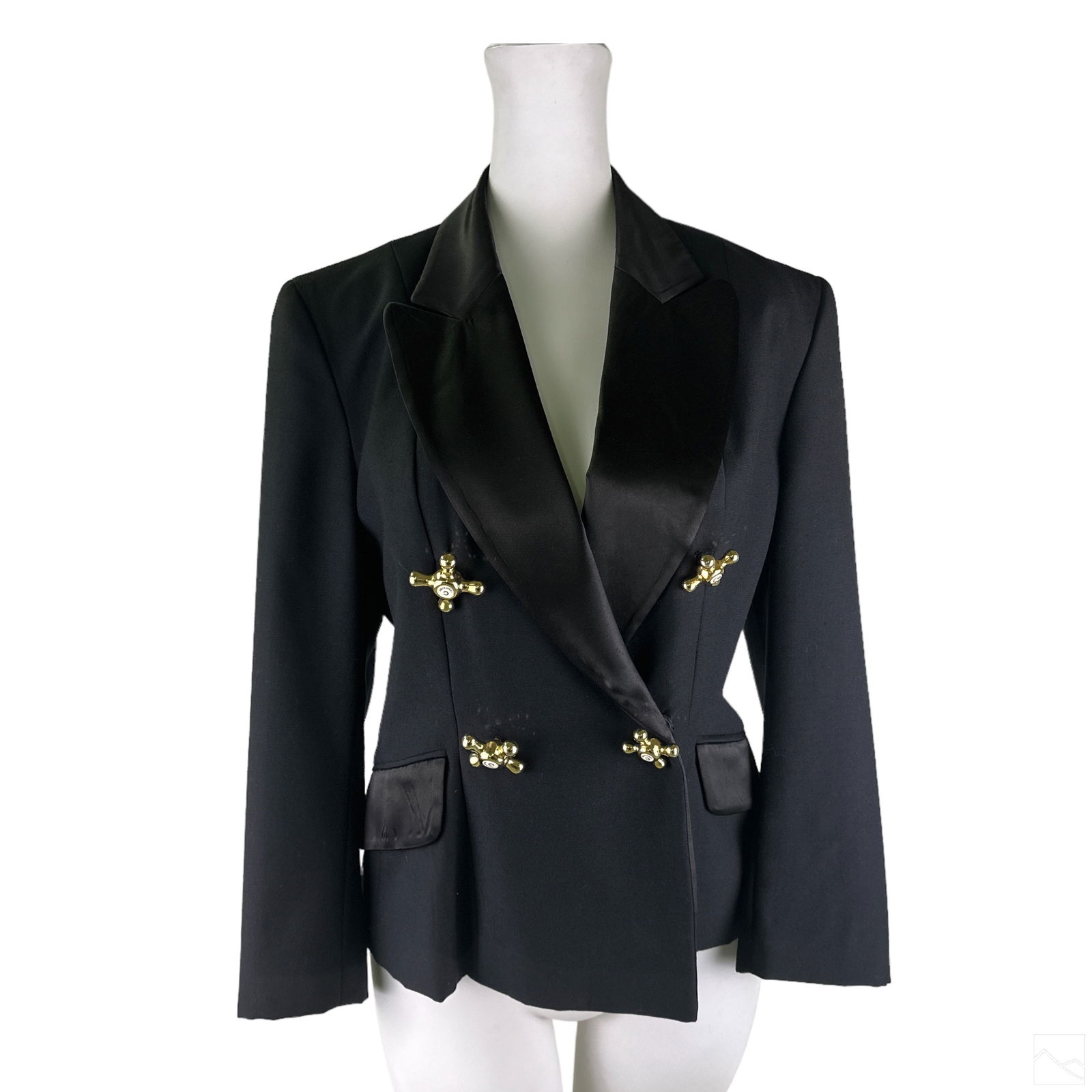 Moschino Italian Designer Couture Faucets Jacket: An Italian designer ladies blazer jacket, by Franco Moschino (1950-1994). Produced circa 1990s. Elegant black wool gabardine jacket embellished with black satin collar lapels and pockets, and decorate
