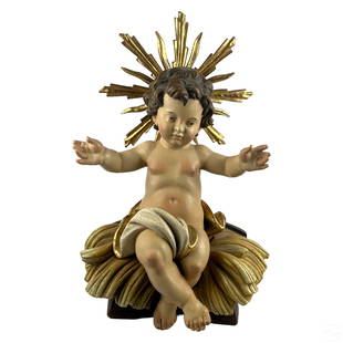 Italian Carved Wood Baby Jesus Gilt Icon Sculpture: An Italian artisan hand carved wood statue by Bergland (Italy). A figural work depicting Jesus as a child seated on a wood bench with radiant gilded starburst aureola halo to back of head, and realist