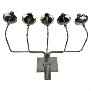 Tommi Parzinger Style Modernist Chrome Candelabra: A five arm chrome metal candelabra produced circa 1950s in the style of Tommi Parzinger (1903-1981) for Dorlyn Silversmiths. Mid Century Modern design with extendable arms mounted on a rectangular bac