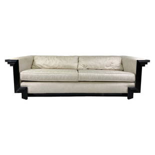 Interior Crafts Style Art Deco Stepped Couch Sofa: A designer living room sofa, produced circa 1980s in the style of Interior Crafts (Chicago). Moderne design with double cream fabric upholstered seat cushions and elongated backrests fitted in a stepp