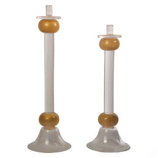 Murano Elio Raffaeli Venetian Glass Candlesticks: Set of two (2) Murano Italian studio art glass candlestick holders by Elio Raffaeli (born 1936). Modern clear glass cylinder stems with orb decorations encased with gold flakes. Surmounting clear circ