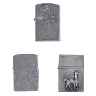 Vietnam War Era Silver Cigarette Lighters 3pc LOT: An estate grouping of three (3) vintage polished silver tobacco lighters. Classic designs with hinged flip lids. Includes: one (1) featuring impressed botanical and scrolling patterns to exterior (no