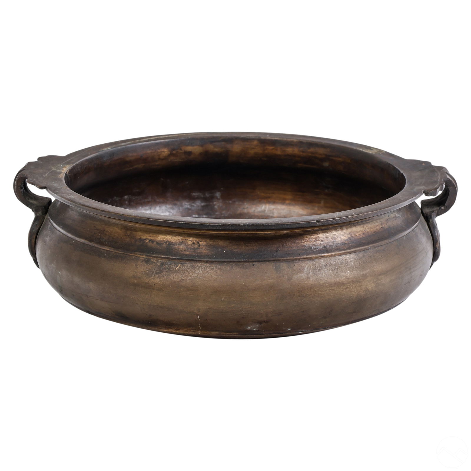 Southeast Asian Indian Antique Bronze Urli Bowl: An antique bronze Asian Urli bowl. Cast bronze featuring a round squat form with simplistic lines and two looped handles. Vessel primarily used in cooking for ceremonies and religious gatherings. The