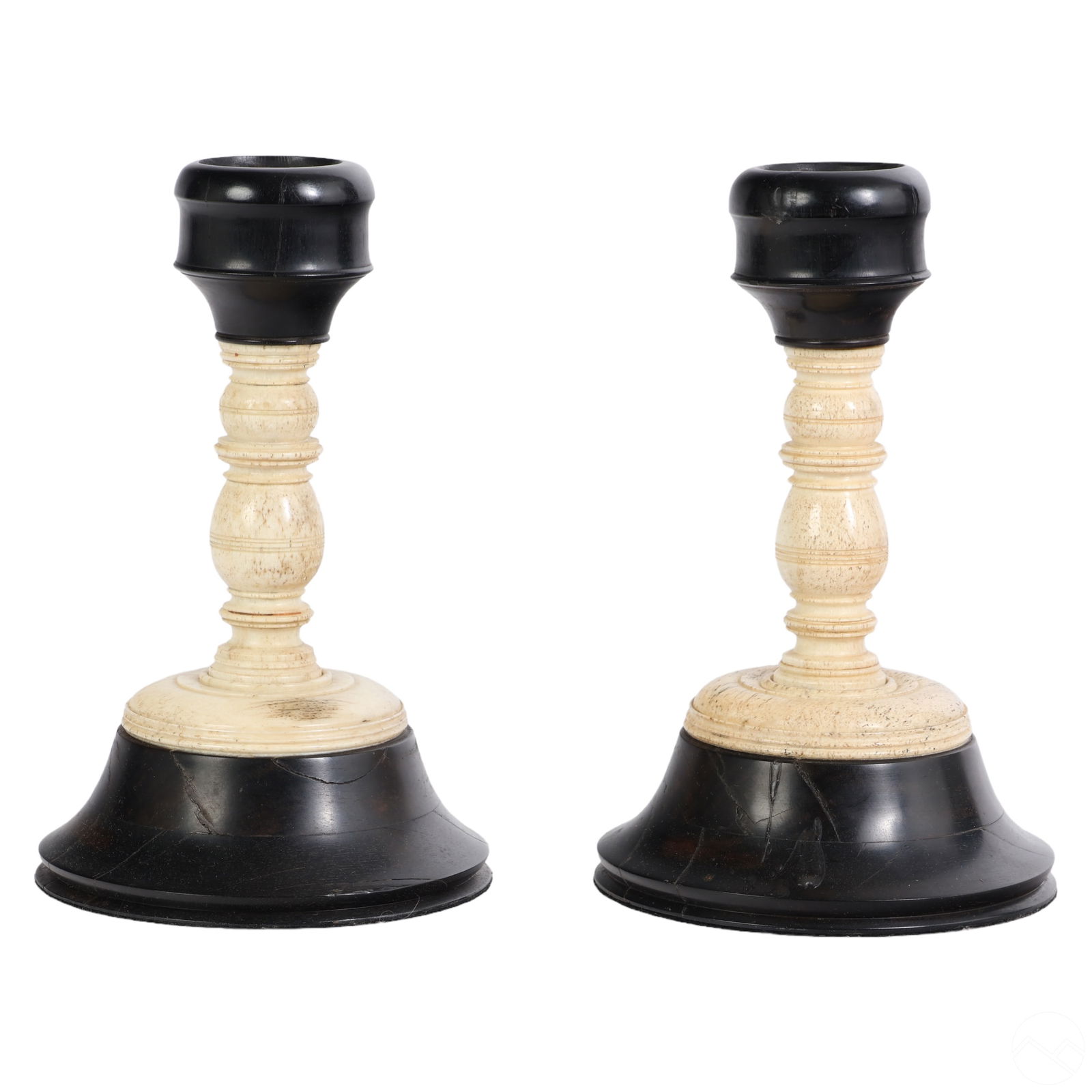 Antique Pair of Bone and Ebony Wood Candlesticks: A pair of antique wooden candle stick holders. Carved natural bone with ebony bobeche candle holders and wide bases. No apparent maker's mark. Felt protectors to bottoms. Dimensions: 9 X 5.5 X 5.5 in.